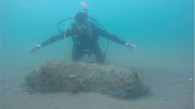 Diver in Teignmouth inspecting a WWII bomb which was destroyed in a controlled explosion.