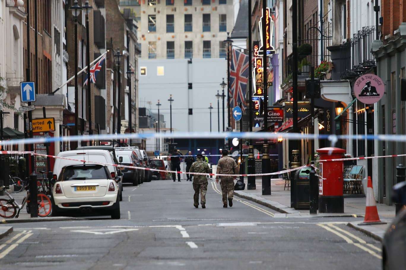 Police and bomb disposal experts cordoning off the scene following the discovery of a 500kg WWII bomb on Soho construction site.
