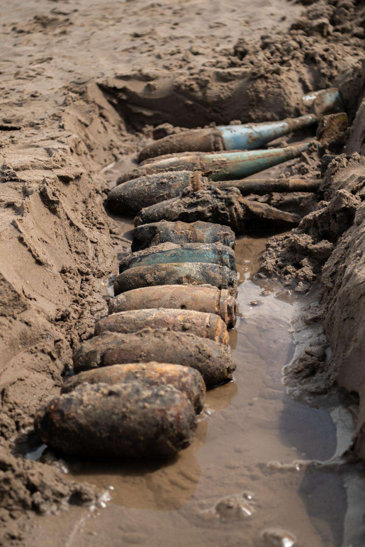 Several items of unexploded ordnance being stored in a makeshift trench on the beach at Cowden Sands in Yorkshire. Image source: Gazette & Herald