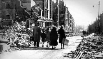 Family walking through the devastated streets of Clydebank after the WWII Blitz in 1941