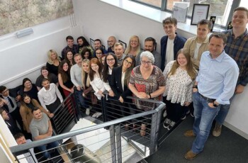 1st Line Defence Team standing together in their office space