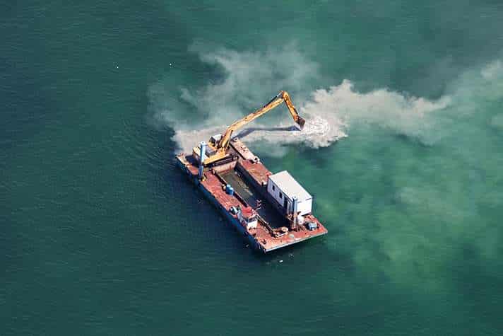 Industrial excavator on a platform at sea