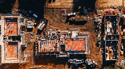 Aerial view of a construction site showcasing multiple buildings under development