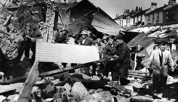 Air-raid Wardens and bystanders clearing rubble after a bomb attack in Penzance, 1943